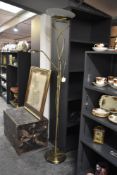A stylish polished brass floor lamp, having central reading light, h182cm.