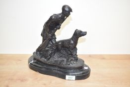 A heavy bronze sculpture of a Hunter and his dog, mounted on a black marble base, signed MENE to