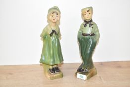 A pair of vintage chalk ware figures of Dutch boy and girl, wearing green garments, h25cm