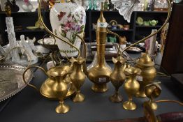 A vintage brass eastern tea pot engraved with symmetrical floral patterns, to include tea pot, water