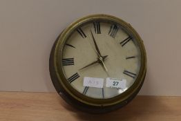 An early 20th century brass ships bulkhead clock with glass front and 4 mounting holes to the