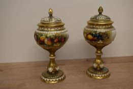 A pair of Royal Worcester porcelain pot-pourri vases and covers, shape number 1813, the bulbous