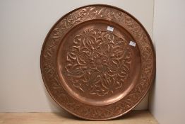 A large early 20th century Keswick School of industrial arts copper charger of circular form,