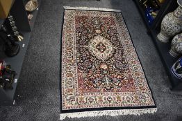 A North West Persian style rug, decorated having floral patterns within a thin dark blue border,
