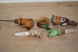 A box containing various vintage bottle openers, comprising of a ceramic horse, a green ceramic