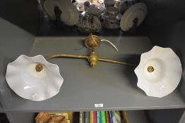 An early 20th century double swan necked copper and glass ceiling light, the opal glass shades in