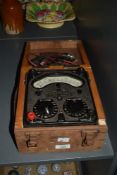 A vintage Universal Avometer with wooden carry case, having D.C ranges, D.C switch and D.C terminal,