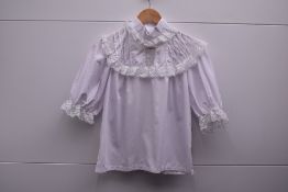 Four 1970s Cobannau white cotton blouses, from the Welsh factory known for the style, which closed