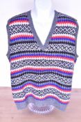 A vintage wool hand-knitted tank top / sweater vest, having a V neck and diamond pattern in grey,