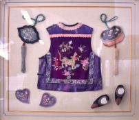 A Chinese framed children's embroidered silk waistcoat and accessories, comprising two tassled