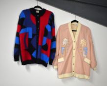 Two 1980s oversized cardigans. A baby pink bomber jacket with cream contrast edging and metallic