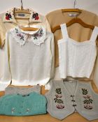 Eight pieces of 1970-1990s women's knitwear, comprising three T-shirts in camel, cream and green,