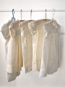 Five 1940s baby girl's dresses, in off white and cream 'Terylene', 'Bri-Nylon, new kinds of