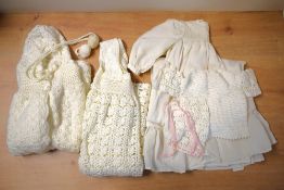 Five newborn baby garments, comprising five hand knitted garments in cream crochet: a bonnet with