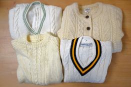 Four peices of 1970s childrens knitwear in cream, comprising a unisex cable-knit crew-neck
