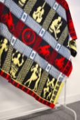 A 1950s-1960s wool blanket in vibrant yellow, red, powder blue, black and white fuzzy knit, having a