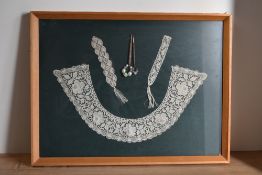 Three examples of 19th or 20th century handmade lace, framed, alongside two wooden lace making