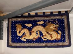 A highly ornate beaded banner or wall hanging, on blue silk and velvet, featuring an extravagant