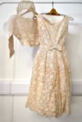 A 1940-50s Heiress short wedding dress, in blush with chantilly lace overlay, having a boat