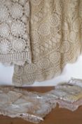 A collection of 20th century crochet, cotton and lace tableware in shades beige, off-white and blush
