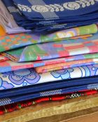 A quantity of various tablecloths and place settings, including a 1960s-70s cornflower floral