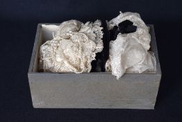 Two handmade baby bonnets or coifs, in off white French or Alencon lace, featuring floral embroidery