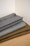 Three bolts of vintage tailor's fabric, including a wool houndstooth in teal and brown, a grey
