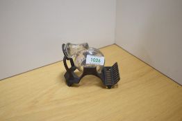 A snail form glass reservoir tilting ink well on a brass stand