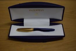 A boxed Waterman Edson rollerball pen in sapphire blue with gold cap. Booklet and refill in box.