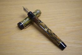 A Parker Duofold Special Lucky Curve button fill fountain pen in black and pearl with three gold