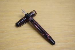 A Parker Challenger button fill fountain pen in black and red marble with one broad gold cap band