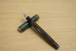 A Parker Moderne button fill fountain pen inn green and gold marble with single gold cap band having