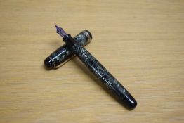 A Parker Televisor Standard button fill fountain pen in lined green with three gold cap bands having