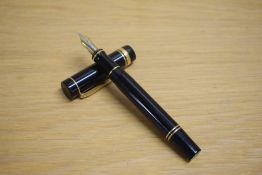 A Parker Duofold Centennial converter fill fountain pen in black with gold trim and one broad one