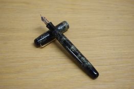A Parker Televisor Standard button fill fountain pen in lined green with three gold cap bands having