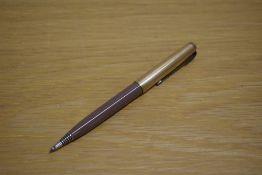 A Parker 51 propelling pencil in cocoa with rolled gold cap.