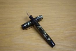 A Parker Duofold Junior Streamlined button fill fountain pen in green and black marble with two