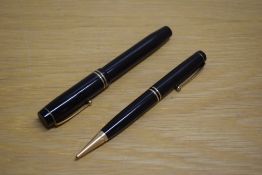 A Parker Duofold Special Short button fill fountain pen and propelling pencil in black with two