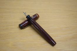 A Parker Premiere button fill fountain pen in mahogany with single gold cap band having Parker