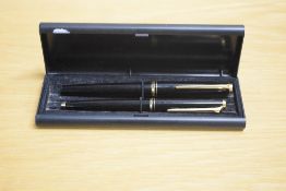 A boxed Montblanc 220 converter fill fountain pen and ballpoint pen set in black