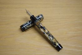 A Parker Duofold senior button fill fountain pen in pearl and black lined pattern with three