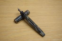 A Parker Premiere button fill fountain pen in grey marble with red specks with single gold cap