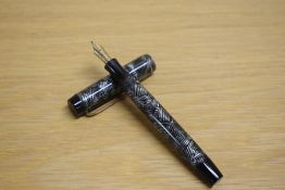 A Parker Duofold Junior button fill fountain pen in grey and black hatched pattern with a single