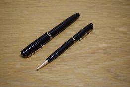A Parker Duofold Victory button fill fountain pen and propelling pencil in black with two gold cap