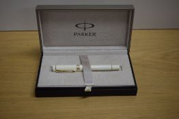 A boxed Parker Duofold International converter fill fountain pen in Ivorine white with gold trim