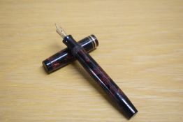 A Parker Duofold Special Streamlined Short button fill fountain pen in rose and black with two cap