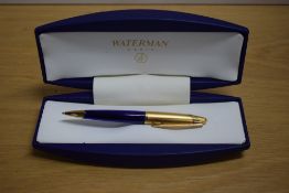 A boxed Waterman Edson ballpoint pen in sapphire blue with gold cap. Booklet and refill in box.