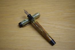 A Parker Duofold Deluxe Junior button fill fountain pen in bronze and gold with three cap bands