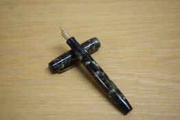 A Parker Duofold Deluxe Special Streamline button fill fountain pen in green and black marble with