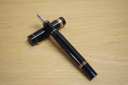 A Parker Duofold Centennial converter fill fountain pen in black with gold trim having Parker 18K